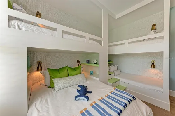 a bedroom with a bed and a wooden floor