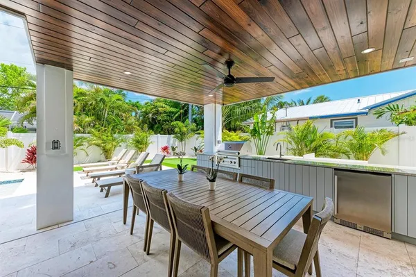 a view of an outdoor dining space with a table and chairs