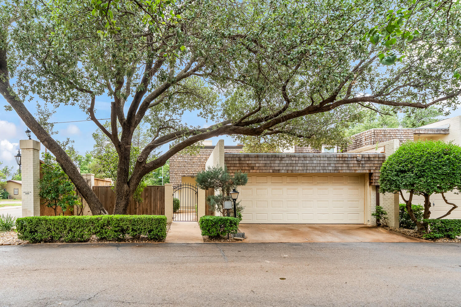 a front view of a house with a yard and a garage