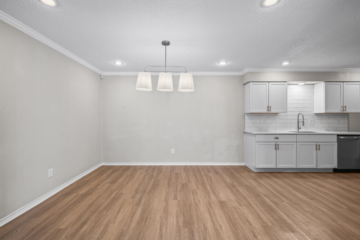 2302 Slide Road, Unit 35 Lubbock, TX 79407 - Photo 12 of 43 a view of a kitchen with a sink and wooden floor