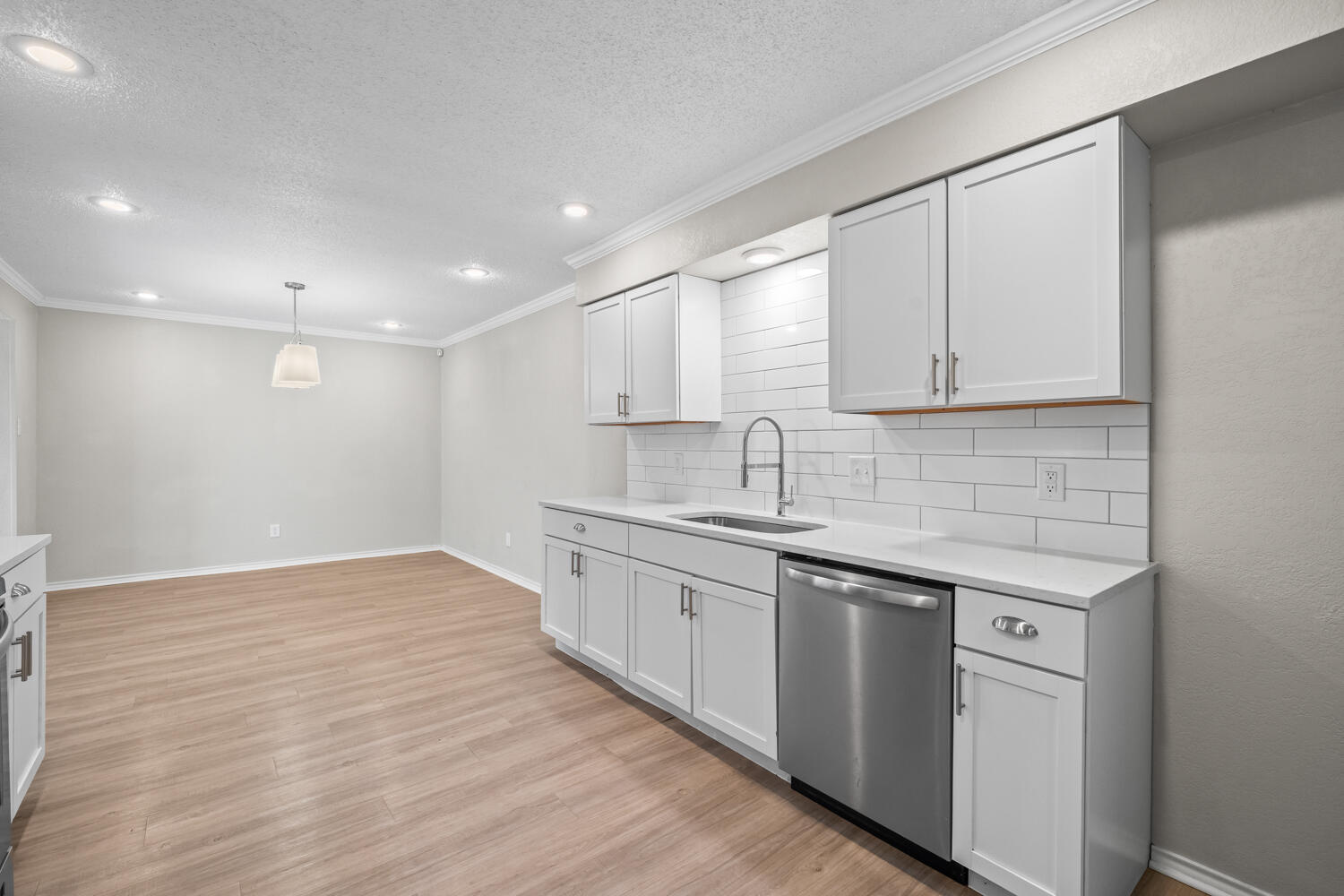 2302 Slide Road, Unit 35 Lubbock, TX 79407 - Photo 14 of 43 a kitchen with granite countertop white cabinets and white appliances