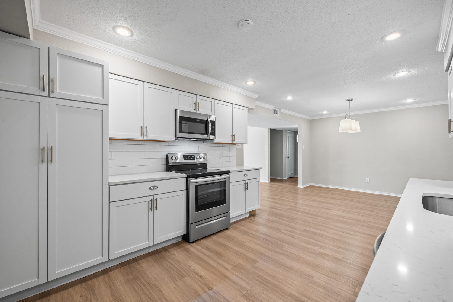 2302 Slide Road, Unit 35 Lubbock, TX 79407 - Photo 15 of 43 a kitchen with a refrigerator stove top oven and sink