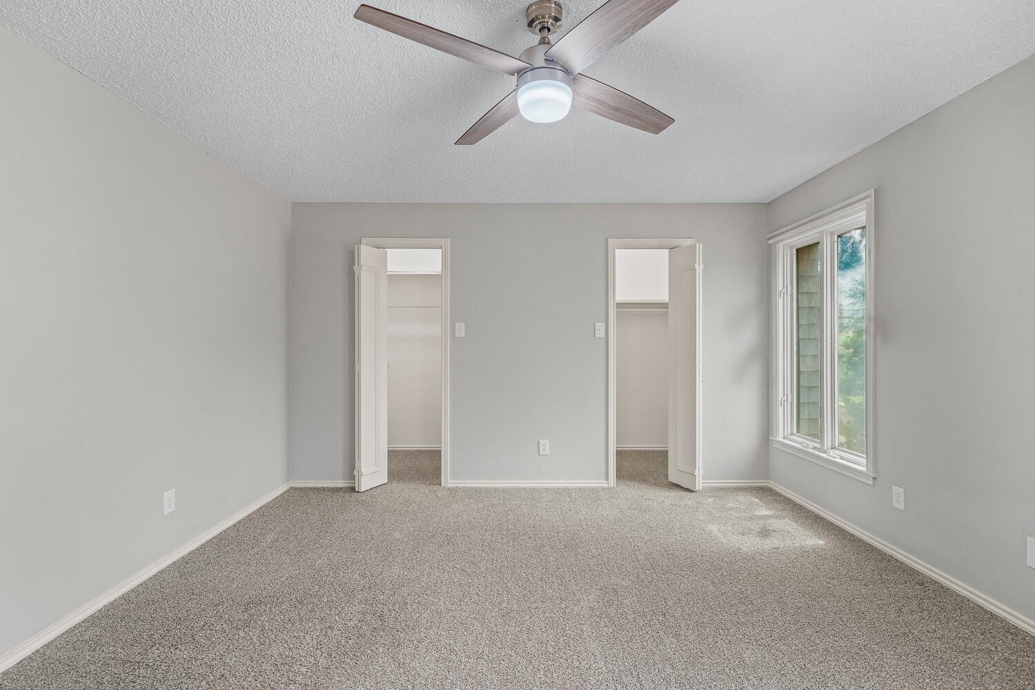 2302 Slide Road, Unit 35 Lubbock, TX 79407 - Photo 17 of 43 an empty room with fan and windows