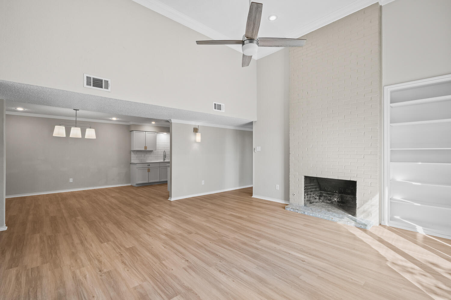 2302 Slide Road, Unit 35 Lubbock, TX 79407 - Photo 2 of 43 wooden floor in an empty room with a fireplace