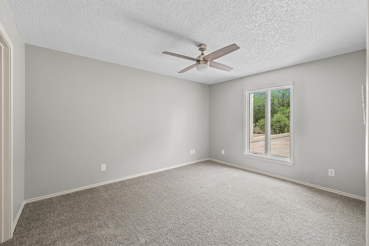 2302 Slide Road, Unit 35 Lubbock, TX 79407 - Photo 25 of 43 an empty room with a window and ceiling fan