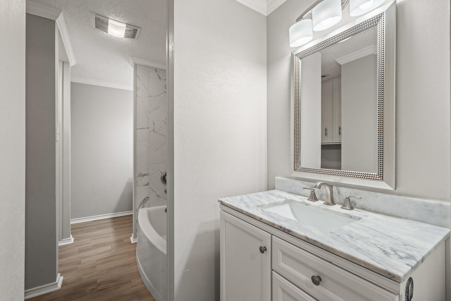 2302 Slide Road, Unit 35 Lubbock, TX 79407 - Photo 30 of 43 a bathroom with a granite countertop sink and a mirror
