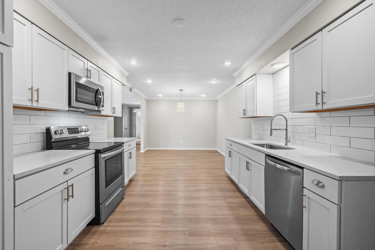 2302 Slide Road, Unit 35 Lubbock, TX 79407 - Photo 3 of 43 a large kitchen with stainless steel appliances granite countertop a sink and cabinets