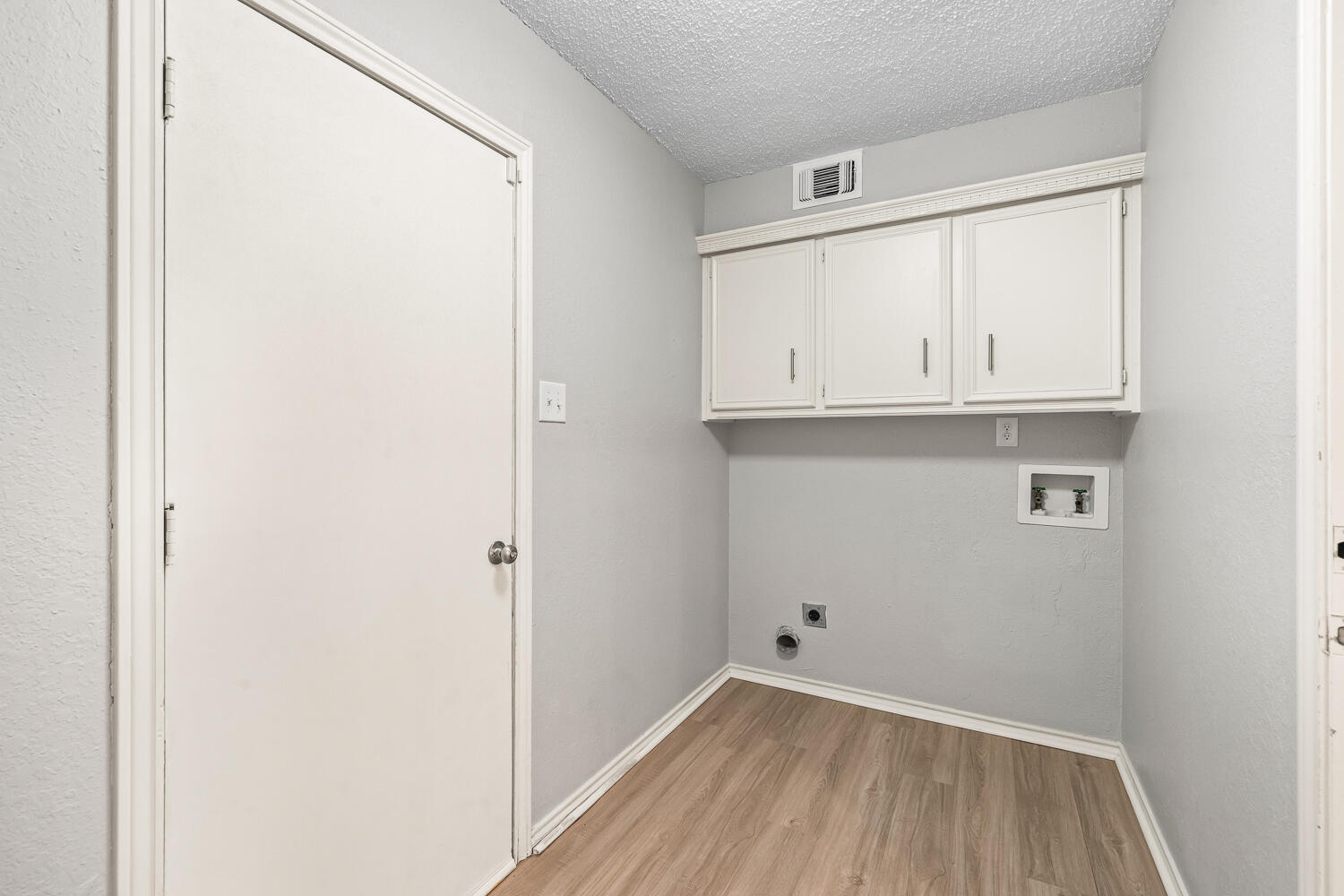 2302 Slide Road, Unit 35 Lubbock, TX 79407 - Photo 35 of 43 a view of cabinets and wooden floor