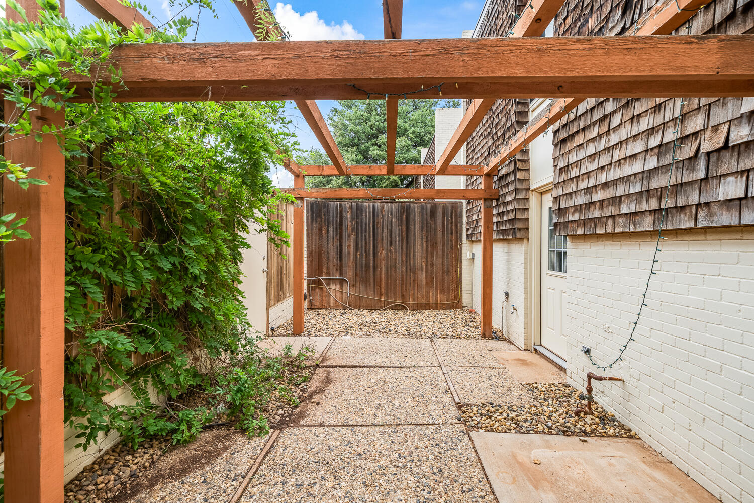 2302 Slide Road, Unit 35 Lubbock, TX 79407 - Photo 39 of 43 a pathway of a house with a yard