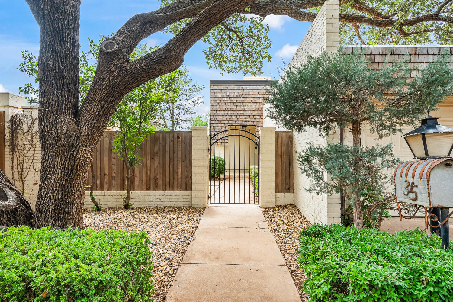 2302 Slide Road, Unit 35 Lubbock, TX 79407 - Photo 4 of 43 a front view of a house with a garden