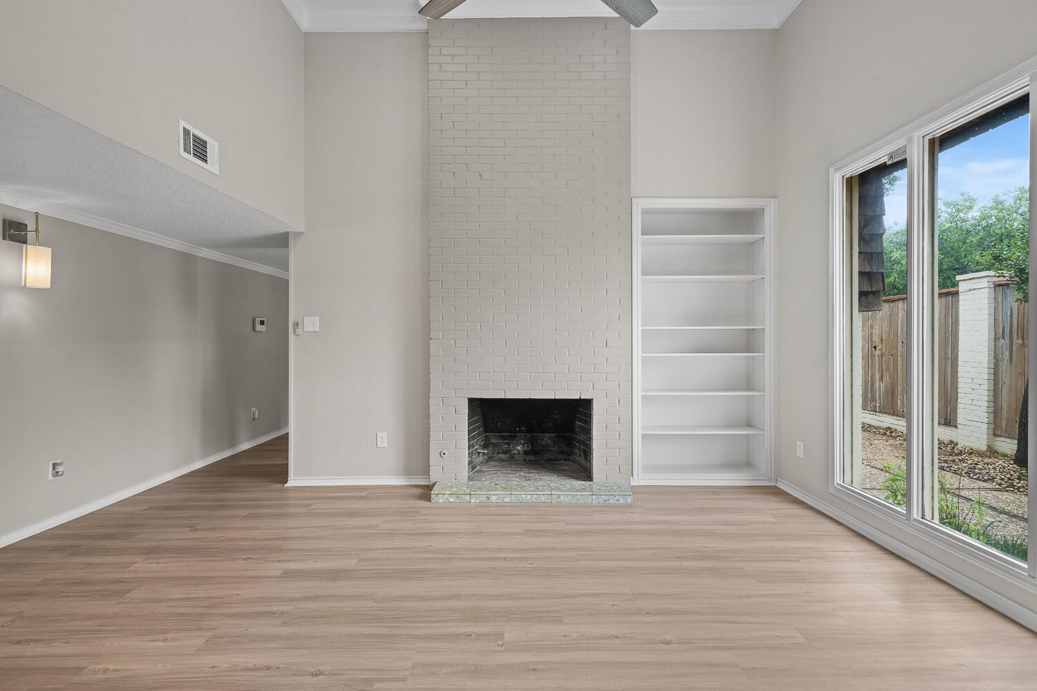 2302 Slide Road, Unit 35 Lubbock, TX 79407 - Photo 7 of 43 wooden floor fireplace and windows in a room