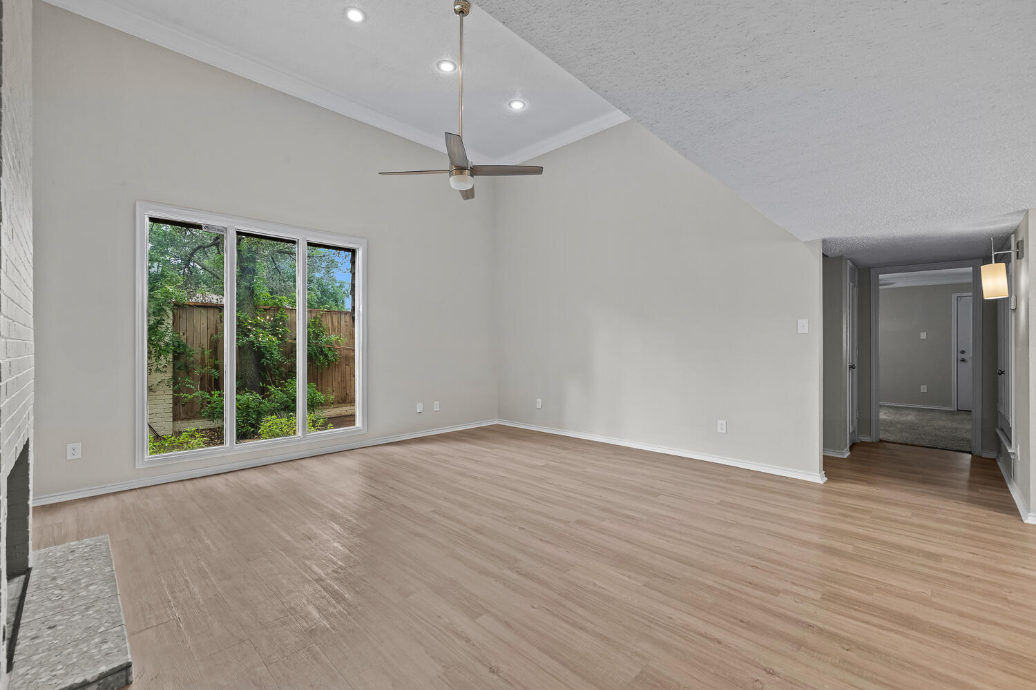 2302 Slide Road, Unit 35 Lubbock, TX 79407 - Photo 9 of 43 an empty room with wooden floor and windows