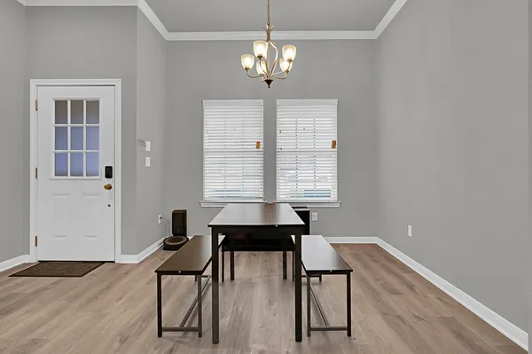 a view of a dining room with furniture and chandelier