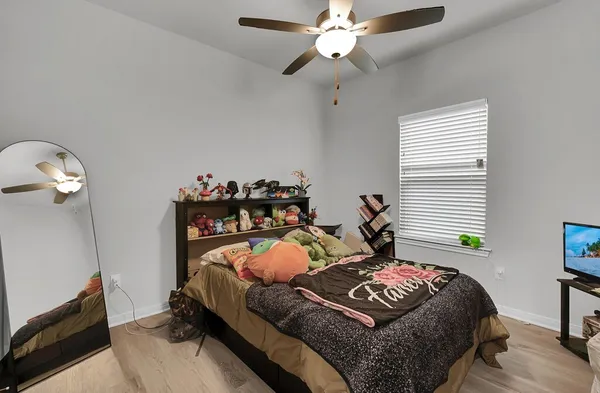 a bedroom with a bed and a chandelier