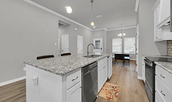 a kitchen with stainless steel appliances granite countertop a sink stove and cabinets