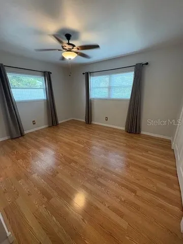 a view of a livingroom with a ceiling fan and window
