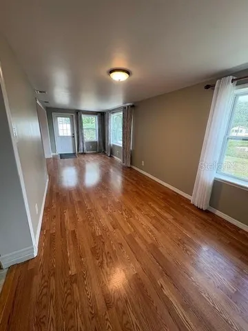 wooden floor in an empty room with a window
