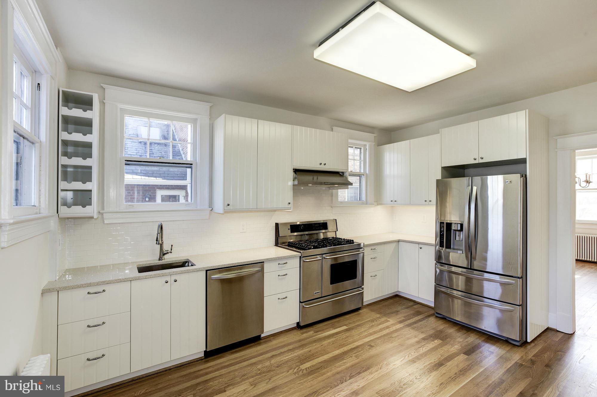 3111 Rittenhouse Street Northwest Washington, DC 20015 - Photo 11 of 30 a kitchen with cabinets stainless steel appliances and wooden floor