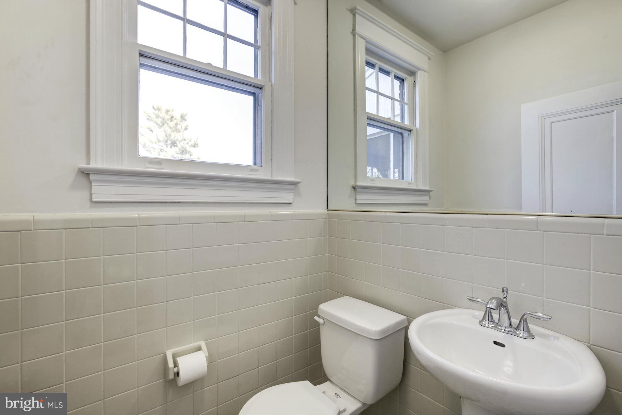3111 Rittenhouse Street Northwest Washington, DC 20015 - Photo 12 of 30 a bathroom with a toilet a sink and a window
