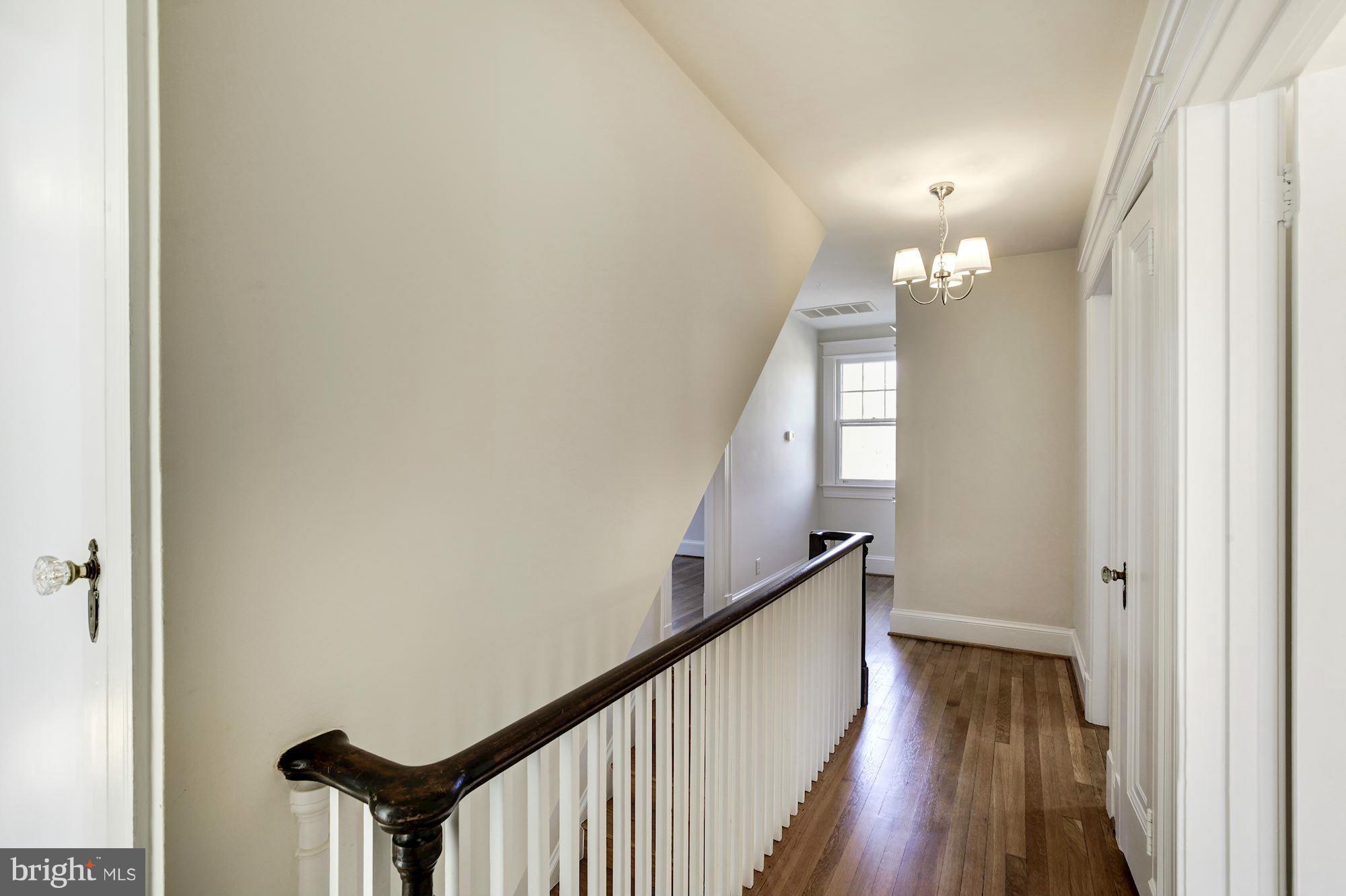 3111 Rittenhouse Street Northwest Washington, DC 20015 - Photo 13 of 30 a view of a hallway with wooden floor and staircase