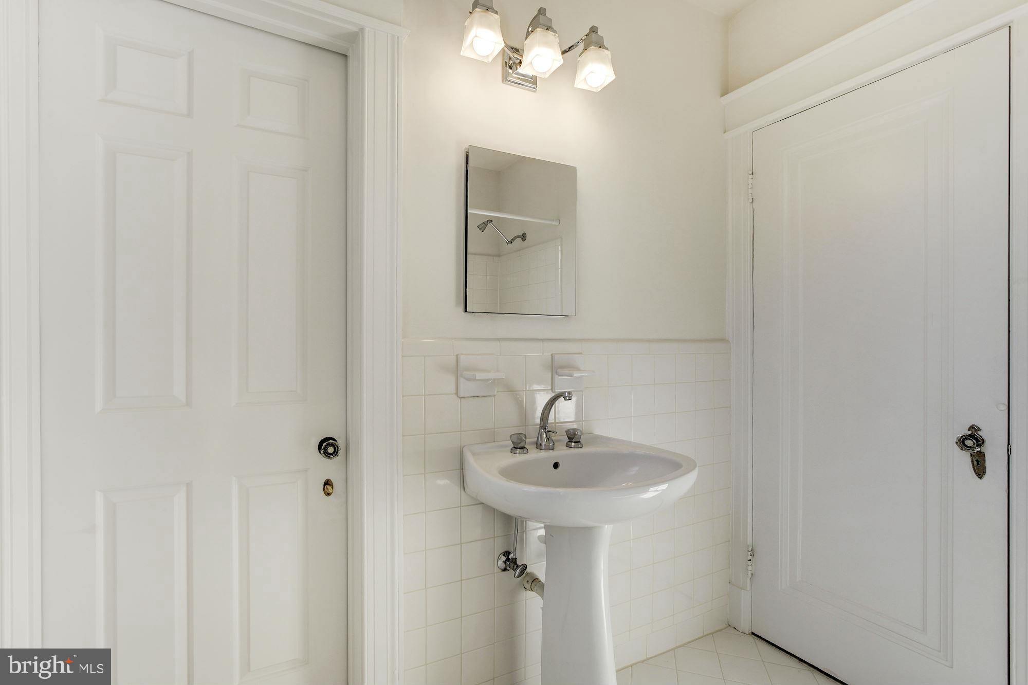 3111 Rittenhouse Street Northwest Washington, DC 20015 - Photo 16 of 30 a bathroom with a sink and mirror