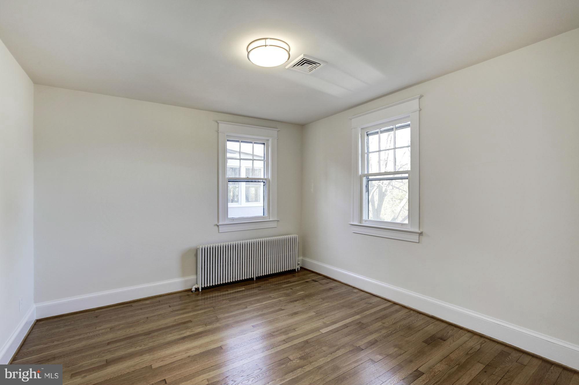 3111 Rittenhouse Street Northwest Washington, DC 20015 - Photo 17 of 30 an empty room with wooden floor and windows