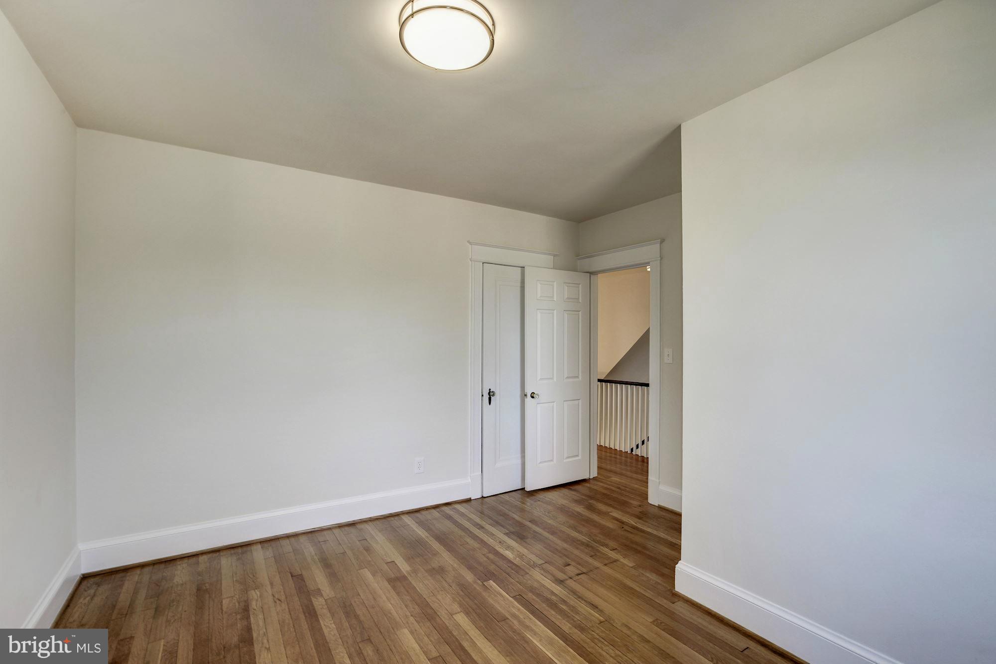 3111 Rittenhouse Street Northwest Washington, DC 20015 - Photo 18 of 30 a view of an empty room and wooden floor