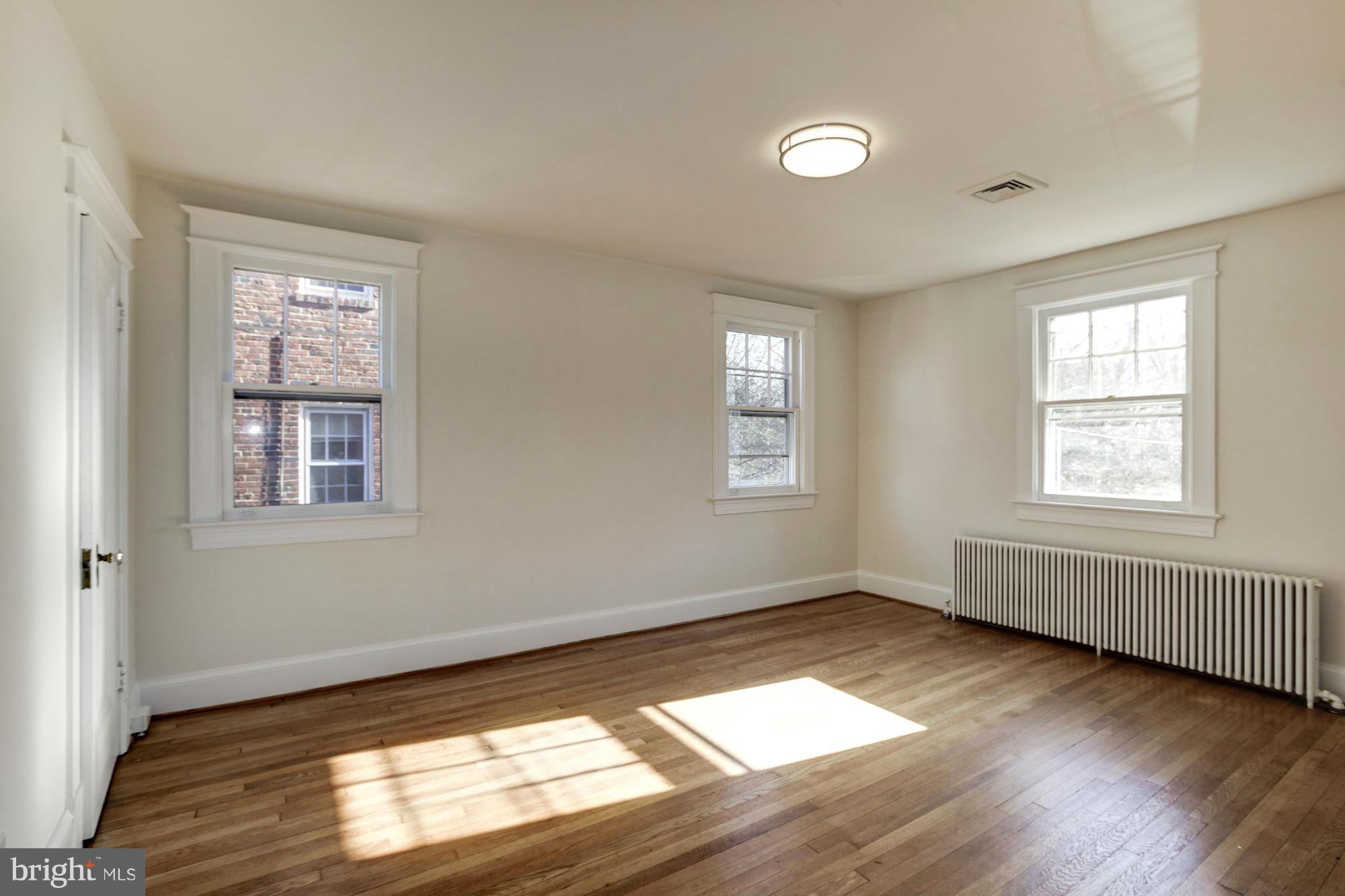 3111 Rittenhouse Street Northwest Washington, DC 20015 - Photo 19 of 30 a view of an empty room with wooden floor and a window