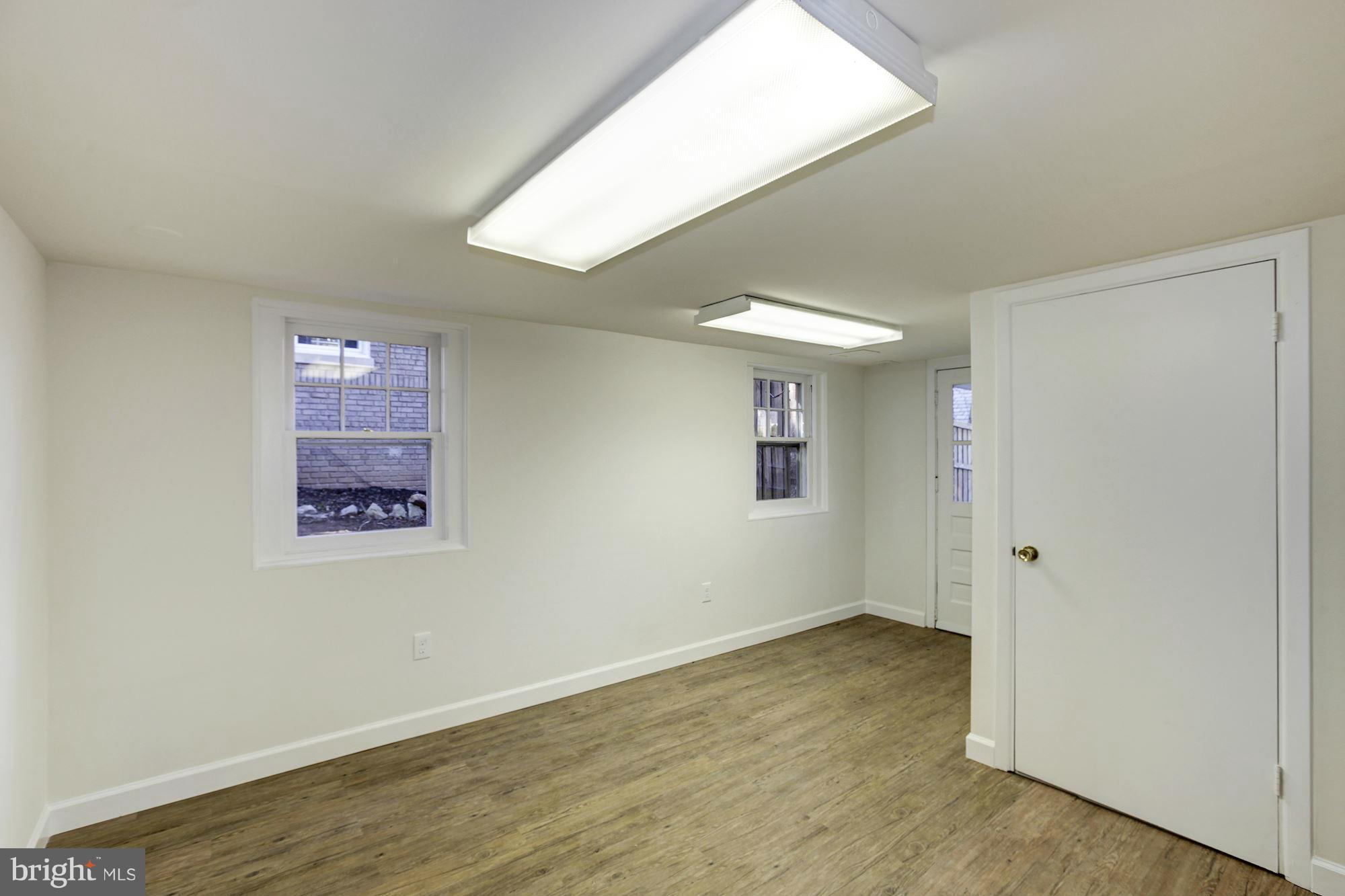 3111 Rittenhouse Street Northwest Washington, DC 20015 - Photo 25 of 30 an empty room with wooden floor and windows