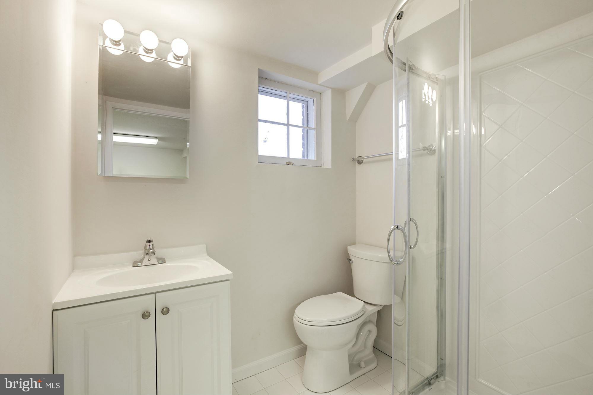 3111 Rittenhouse Street Northwest Washington, DC 20015 - Photo 26 of 30 a bathroom with a toilet a sink a mirror a vanity and window