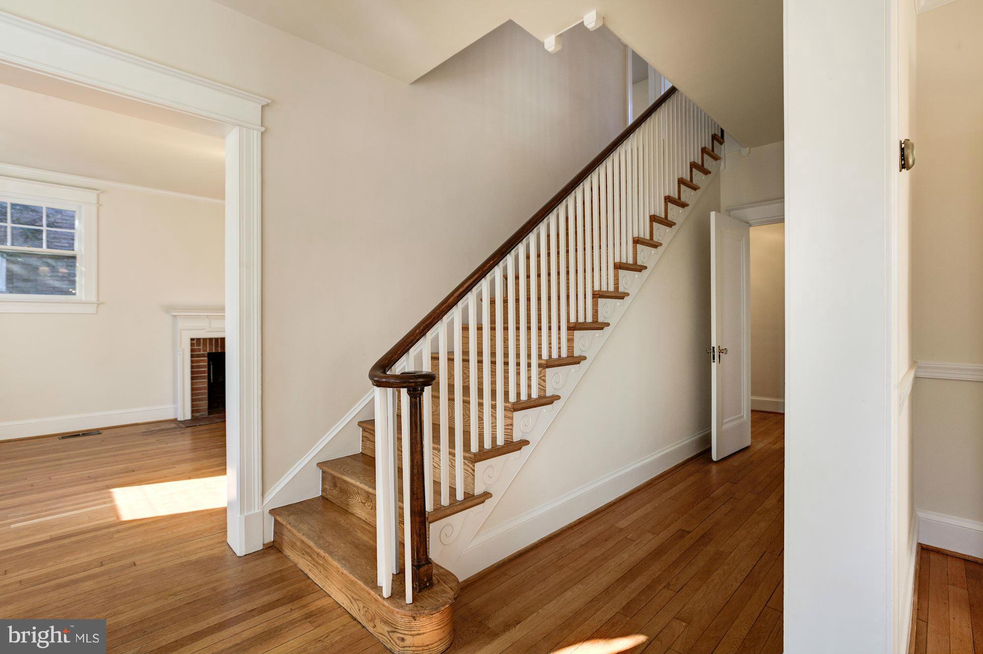 3111 Rittenhouse Street Northwest Washington, DC 20015 - Photo 4 of 30 a view of staircase with wooden floor and white walls