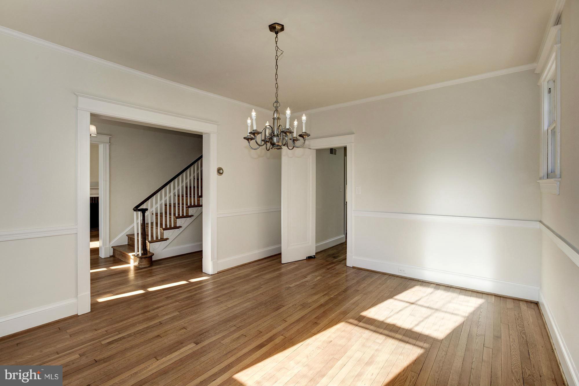 3111 Rittenhouse Street Northwest Washington, DC 20015 - Photo 9 of 30 a view of a room with wooden floor staircase and a kitchen space