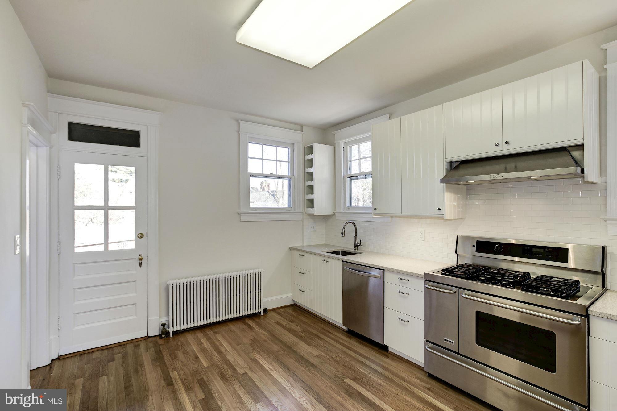 3111 Rittenhouse Street Northwest Washington, DC 20015 - Photo 10 of 30 a kitchen with a sink stove and cabinets