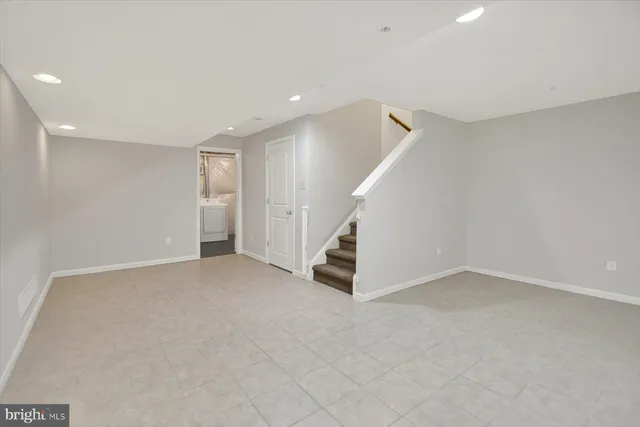 a view of an empty room with stairs