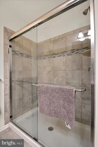 a bathroom with a granite countertop toilet sink and mirror