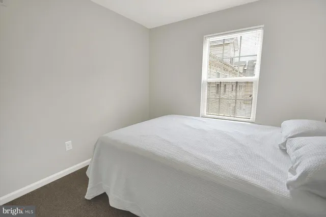 a large white bed in a white room