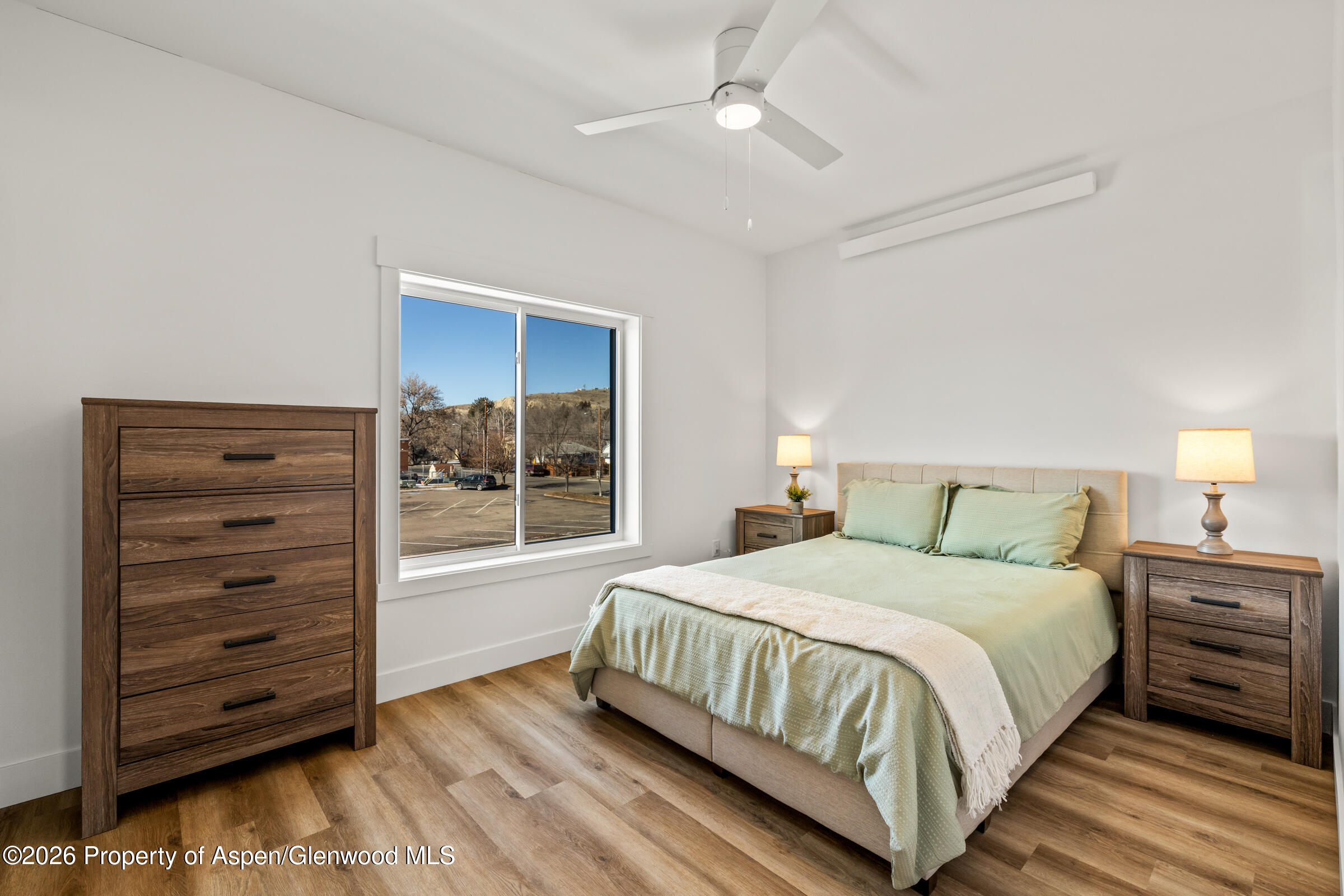766 Tucker Street Craig, CO 81625 - Photo 13 of 22 a bedroom with a bed dresser and a window