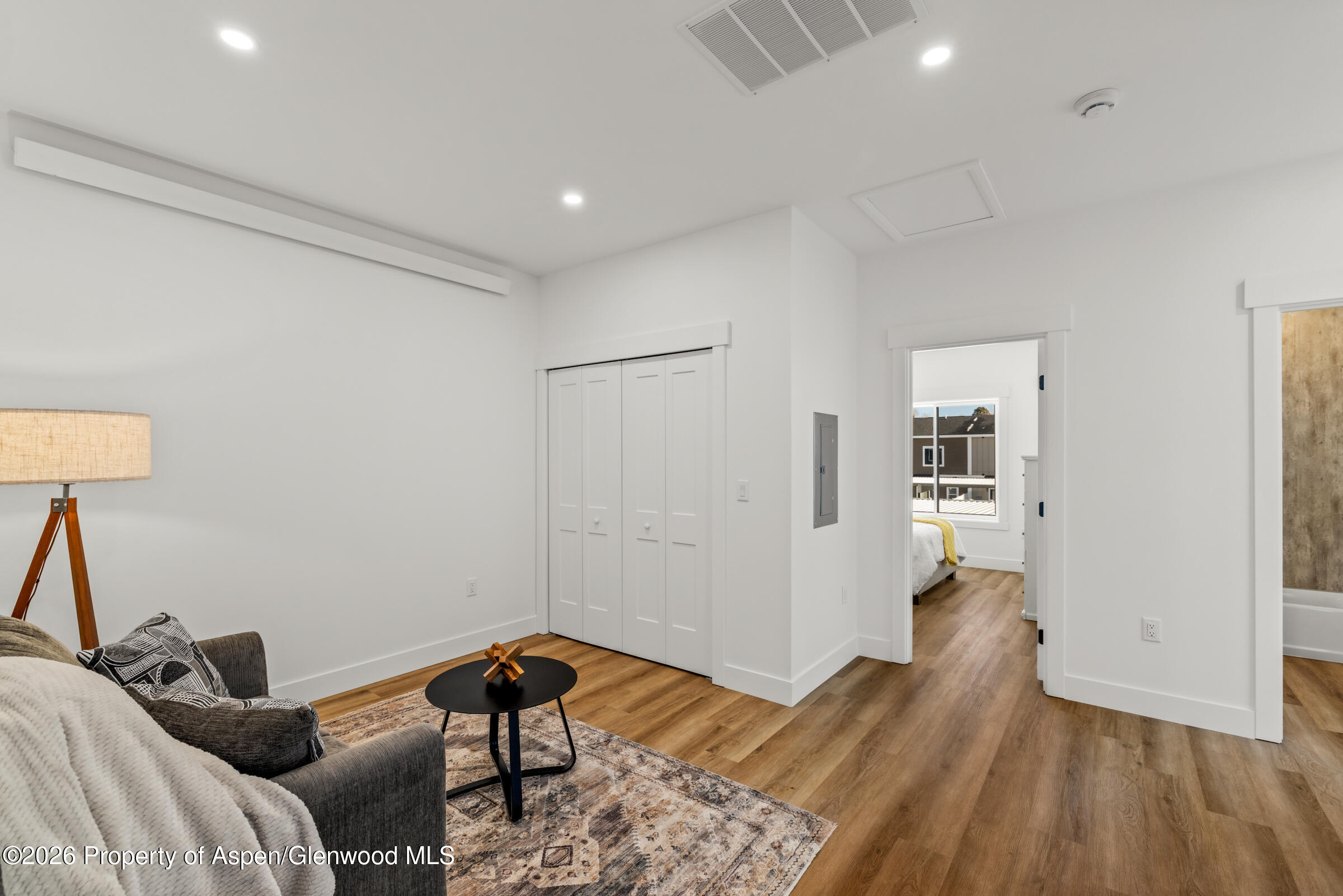 766 Tucker Street Craig, CO 81625 - Photo 16 of 22 a bedroom with a bed and wooden floor