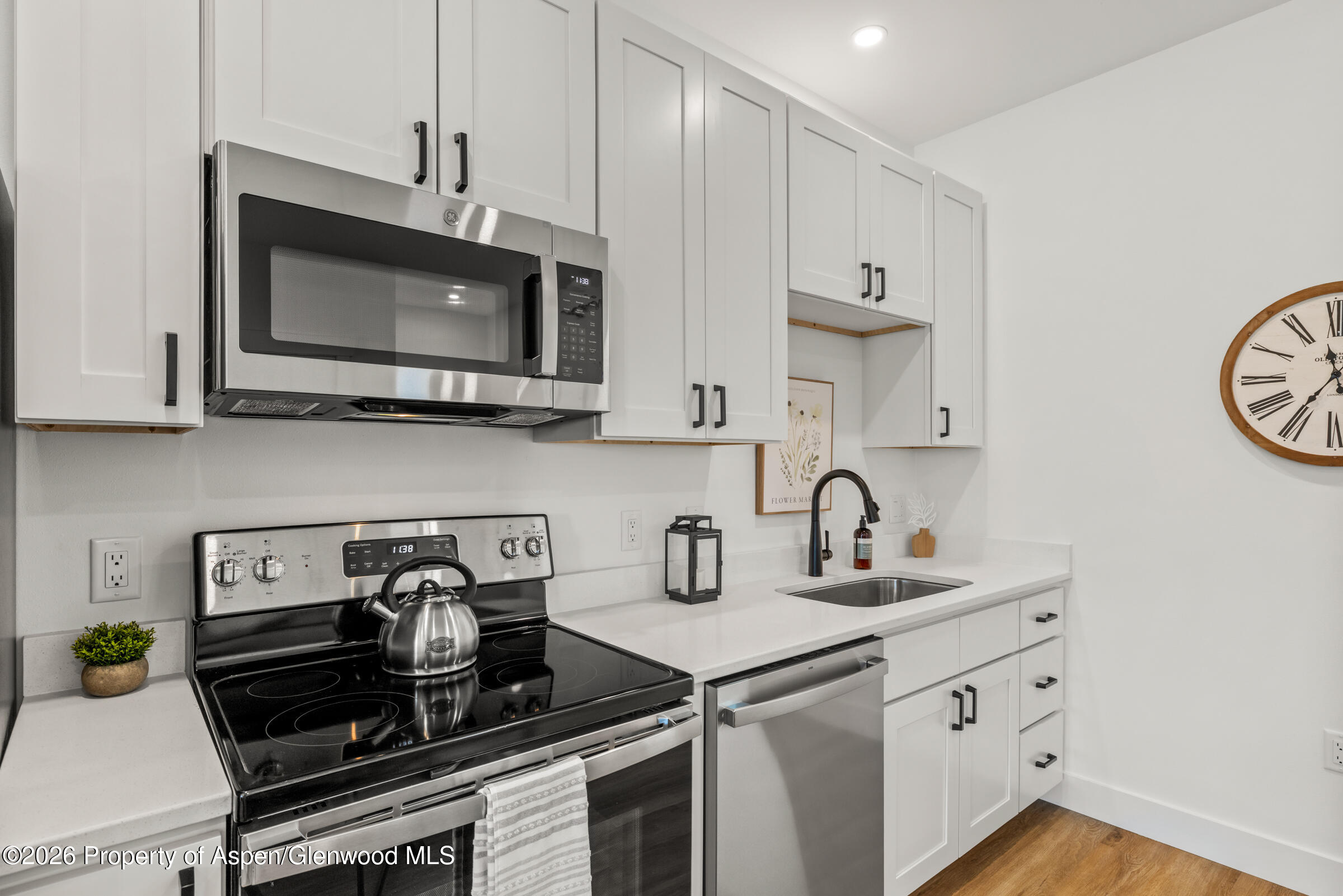 766 Tucker Street Craig, CO 81625 - Photo 5 of 22 a kitchen with stainless steel appliances granite countertop a sink a stove and a microwave