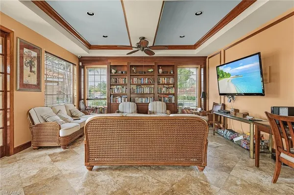 a living room with furniture a flat screen tv and large window