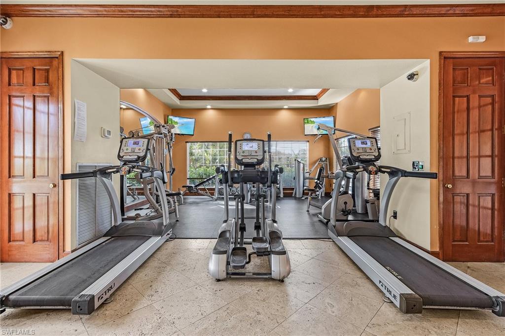 1180 Wildwood Lakes Boulevard, Unit 208 Naples, FL 34104 - Photo 14 of 19 a room with gym equipment