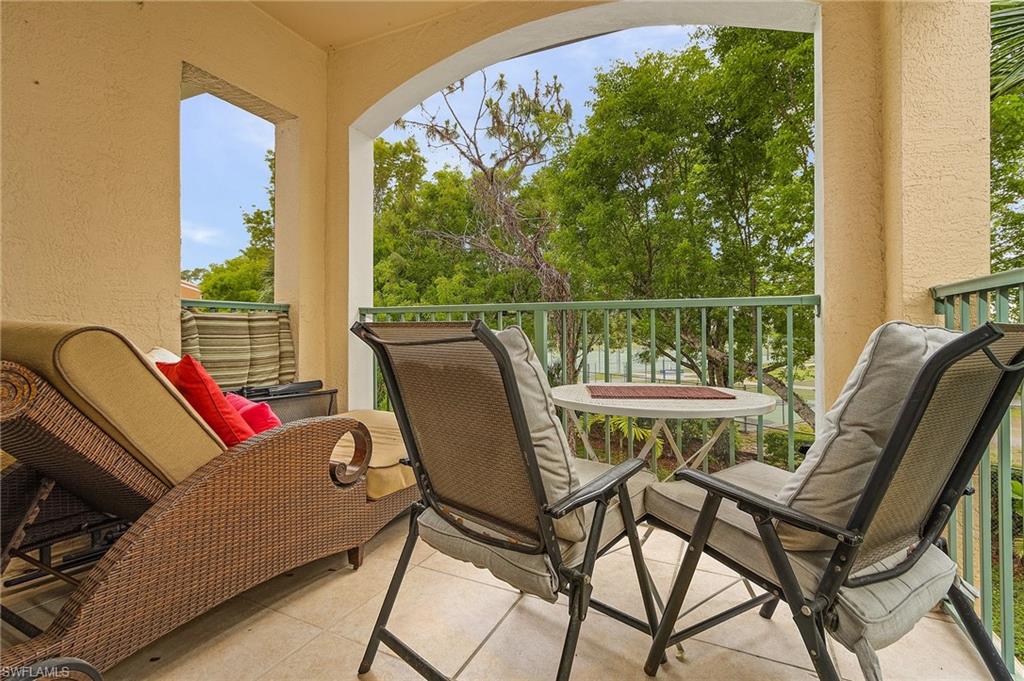 1180 Wildwood Lakes Boulevard, Unit 208 Naples, FL 34104 - Photo 5 of 19 a view of a balcony with chairs