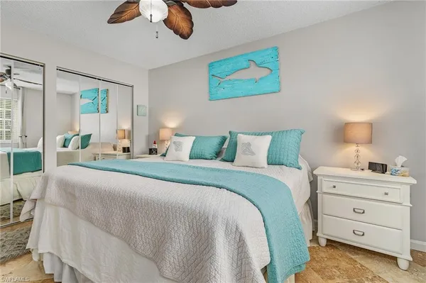 a bedroom with a bed dresser and window