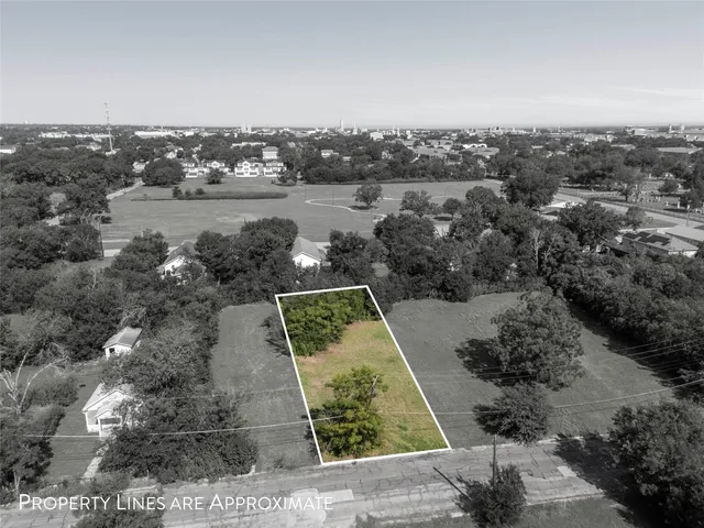 an aerial view of a residential houses with outdoor space