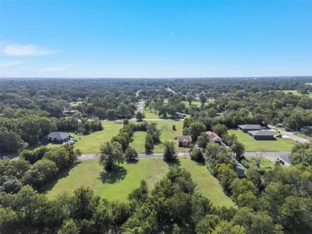 an aerial view of residential house with outdoor space and trees