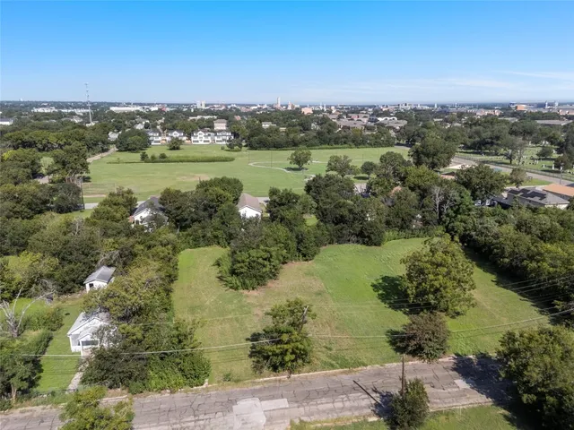 an aerial view of a houses with a yard