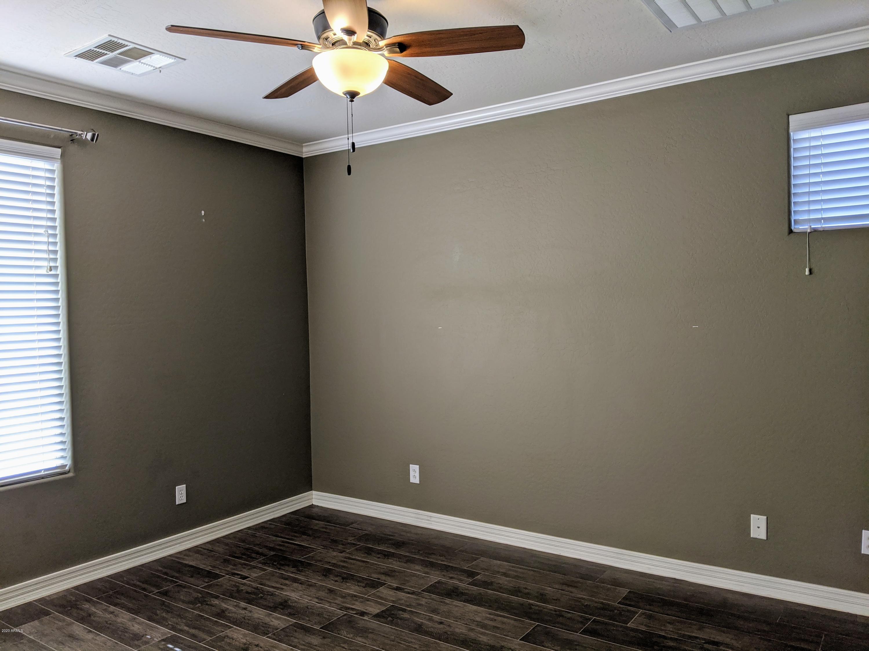 21019 East Avenida Del Valle Queen Creek, AZ 85142 - Photo 11 of 52 an empty room with a window and a fan