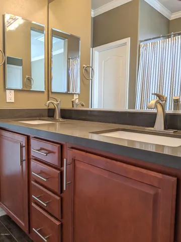 a bathroom with a double vanity sink and a mirror