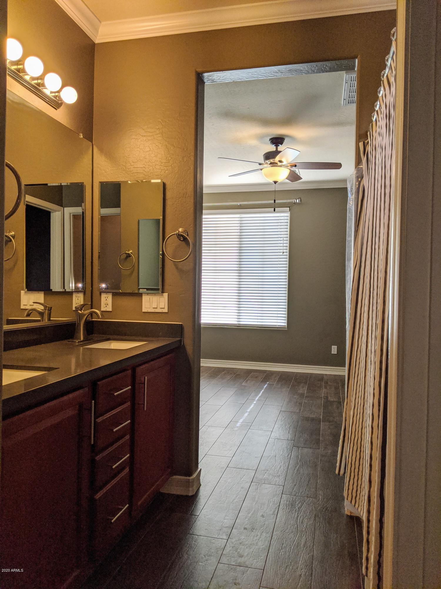 21019 East Avenida Del Valle Queen Creek, AZ 85142 - Photo 17 of 52 a bathroom with a double vanity sink and a mirror
