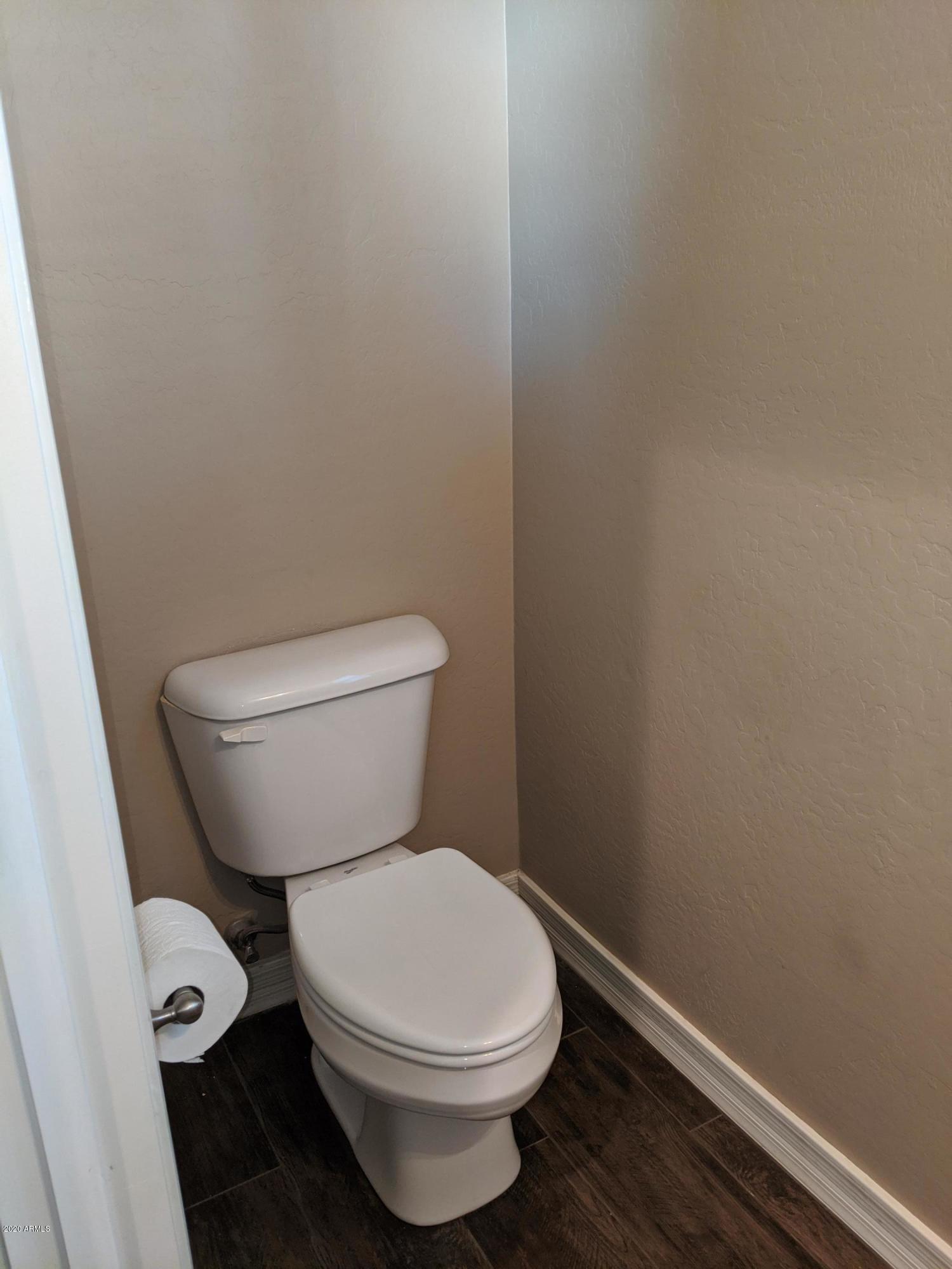 21019 East Avenida Del Valle Queen Creek, AZ 85142 - Photo 28 of 52 a white toilet sitting next to a small sink